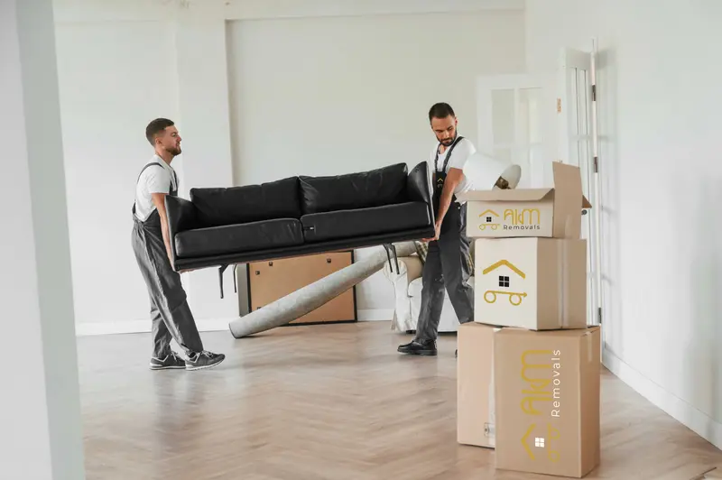 AKM movers carrying a sofa in a family home
