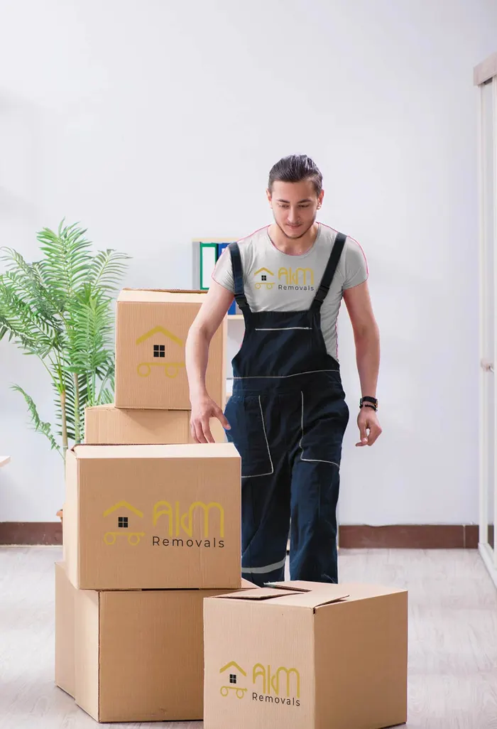 AKM mover stacking branded boxes in a bright room
