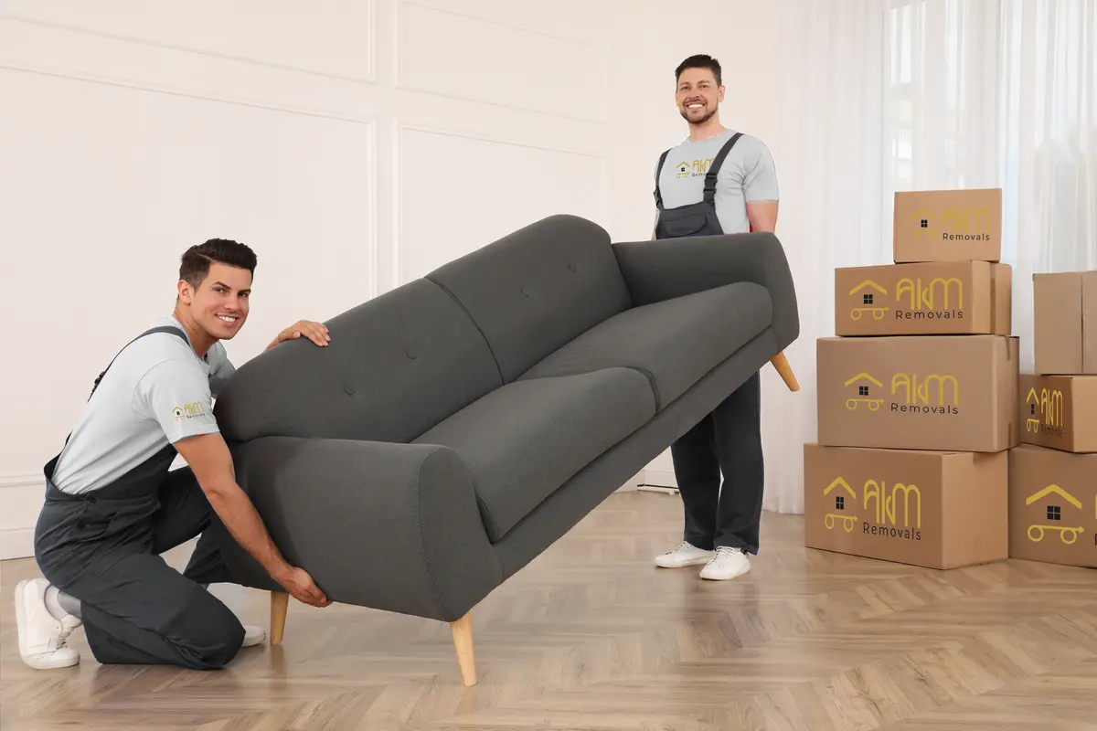 AKM movers carrying a sofa during a furniture move